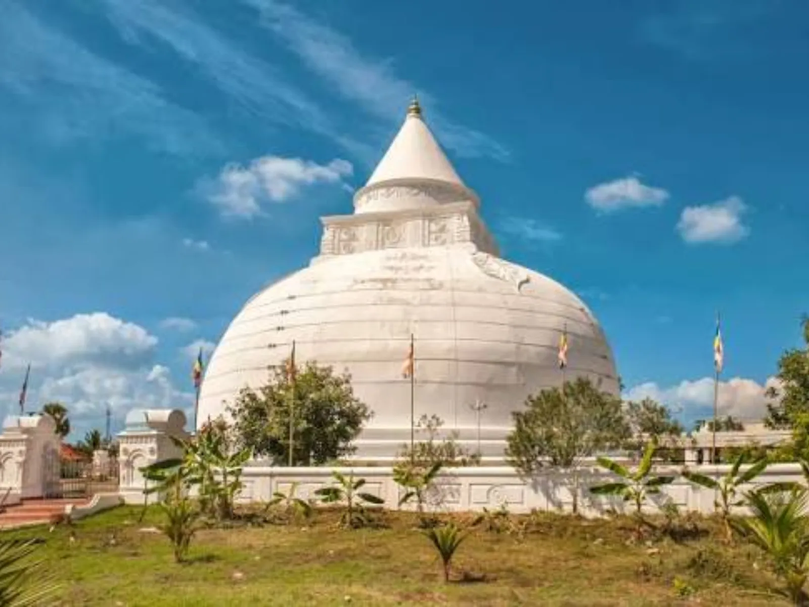 The white bell-shaped Tissamaharama Dagoba against a blue sky