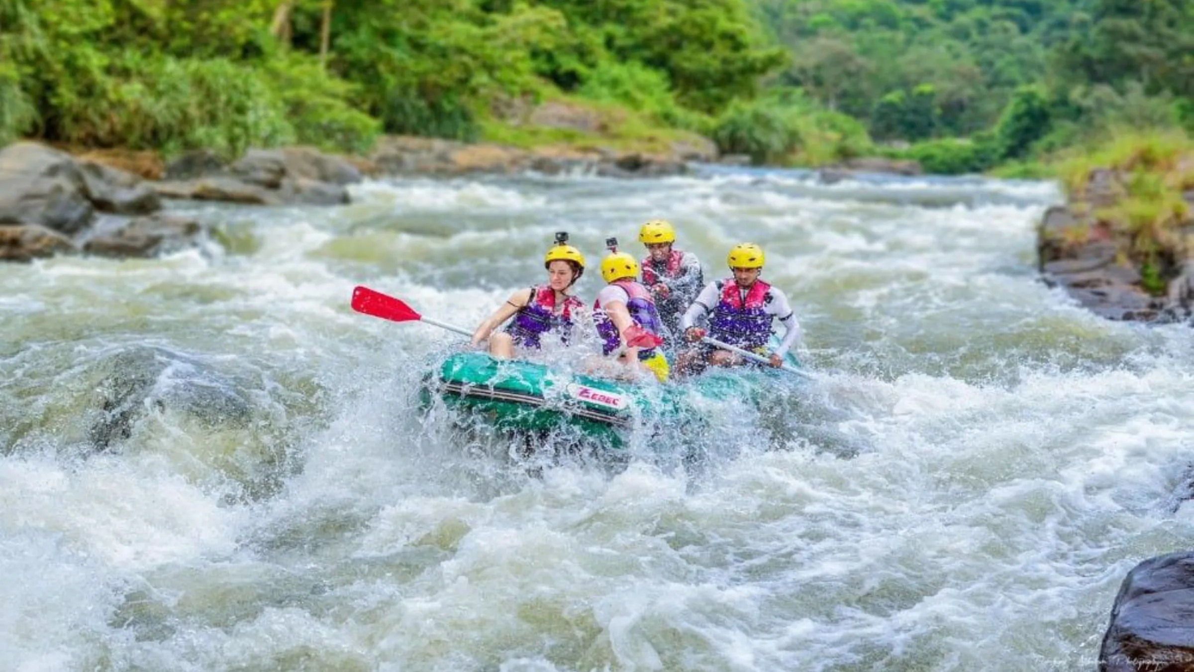A group whitewater rafting through churning rapids on a Sri Lankan river