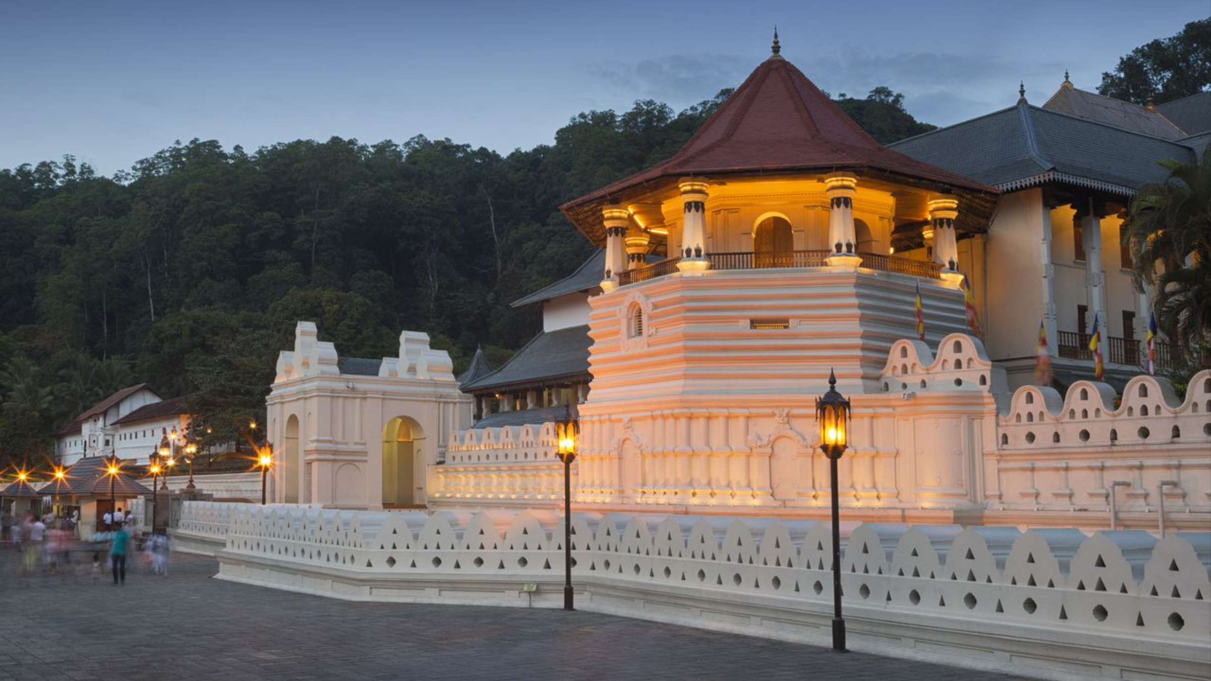 The illuminated Temple of the Sacred Tooth Relic in Kandy at dusk